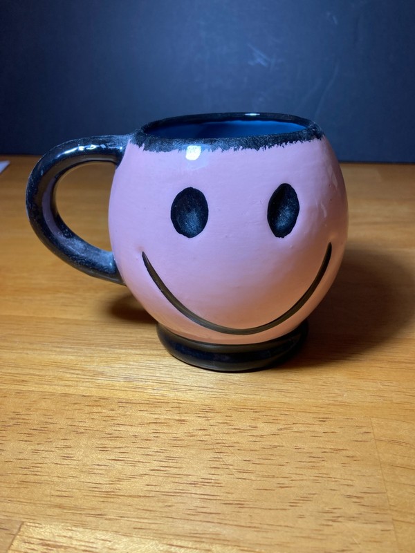 Pink and black smiley face mug