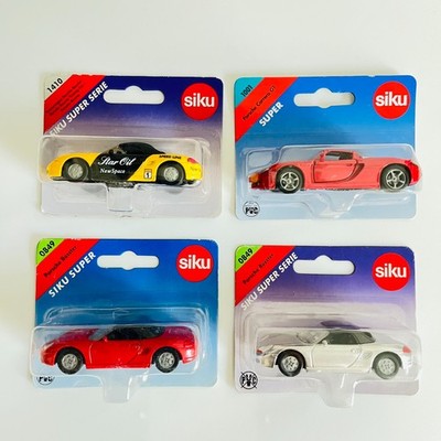 Siku Lot of 4 Porsche: Siku Nos. (2) 0849 Boxster, 1001 Carrera GT, 1410 Touring