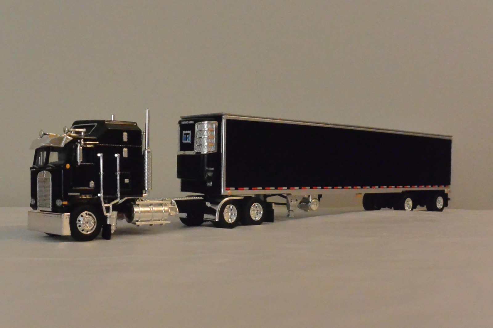 DCP 1/64 Black Kenworth K100C Aerodyne Sleeper & Utility Spread-Axle Reefer