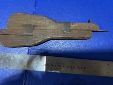 antique wooden tool is a rug hooking shuttle