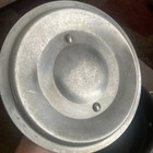 Worn silver metal 2.5 quart double boiler insert with embossed logo, mounted by two metal rivets on a dark surface.