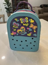 Crocs 10" X 7" Light Blue Zippered Backpack with butterfly decorations