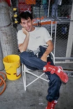 Mauro Martini Suntec Racing sits a small chair the garage area dur 1991 Photo