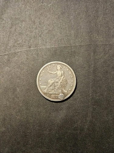 1877 T$1 Trade Dollar. This coin has been holed and repaired.