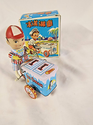 VINTAGE ICE CREAM VENDOR ON BICYCLE TIN WIND UP TOY