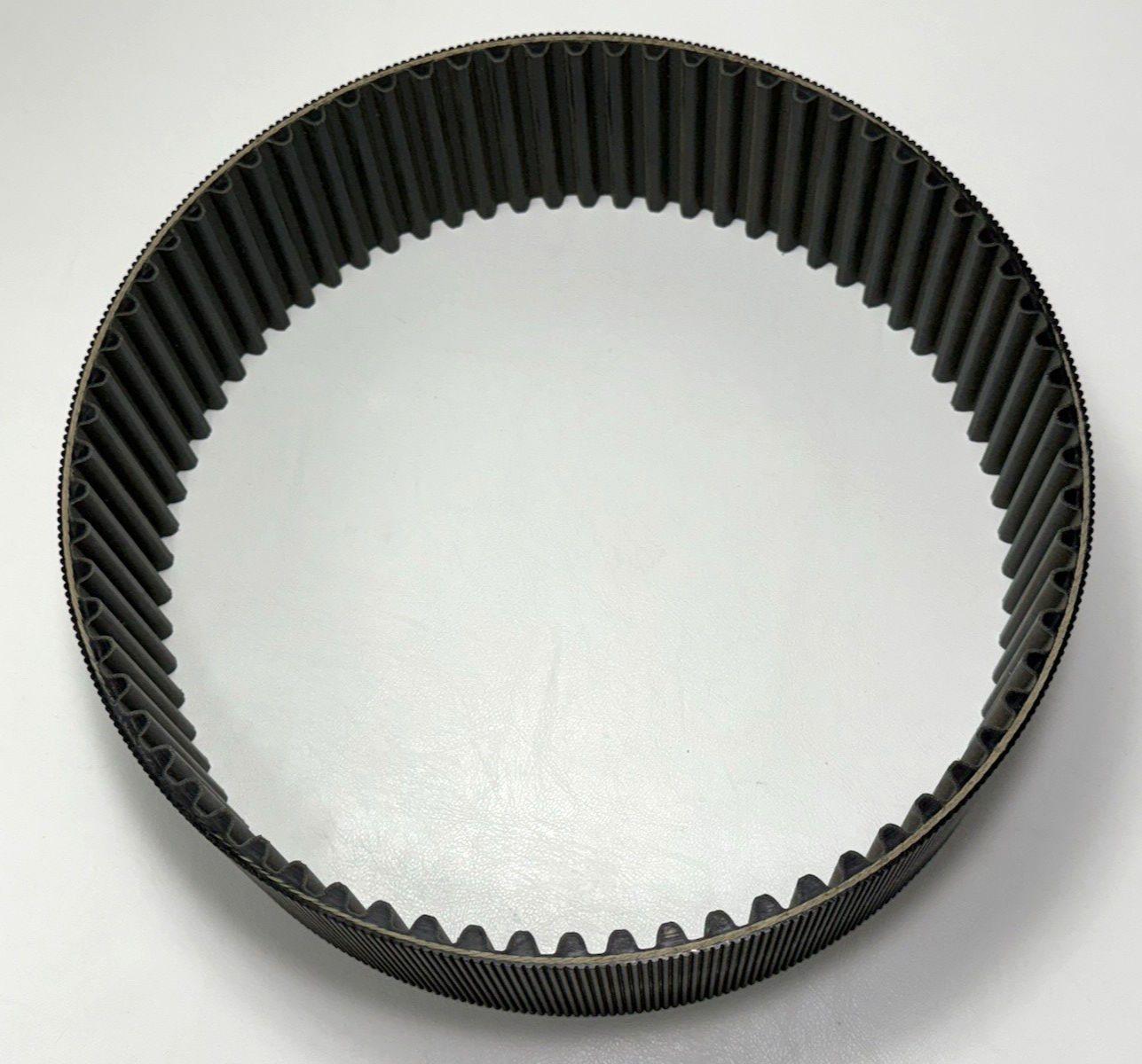 Black GATES 14MGT-994-90 poly chain belt with wide steel ring and ribbed black belt segments on white background.