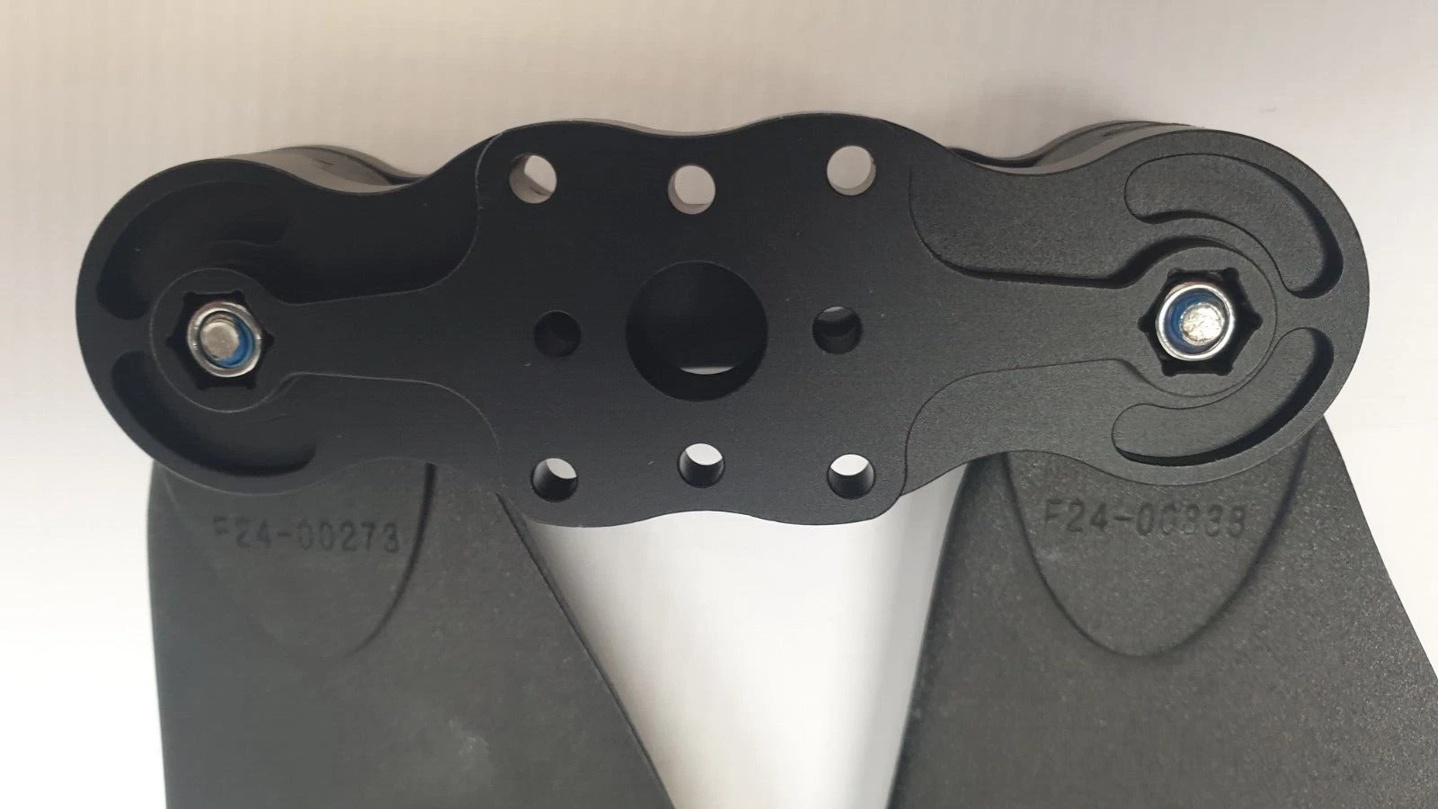 Underside of the propeller hub showing the center bore and mounting hole pattern