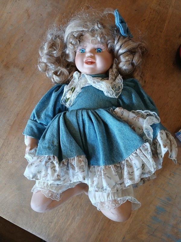 Vintage porcelain doll, often referred to as a bisque doll