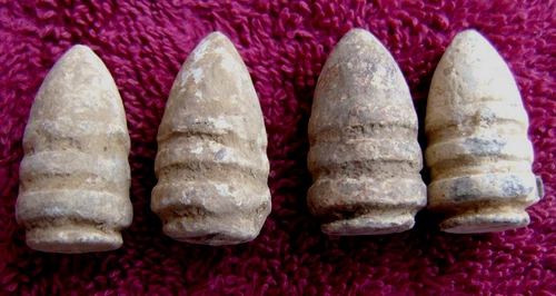 (4) EXCAVATED CIVIL WAR CONFEDERATE DROPPED .56 CAL. "RING TAIL" SHARPS BULLETS