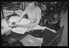 Photo:1930s Woman Typing Office Desk Typewriter Papers Black White Photo thumbnail