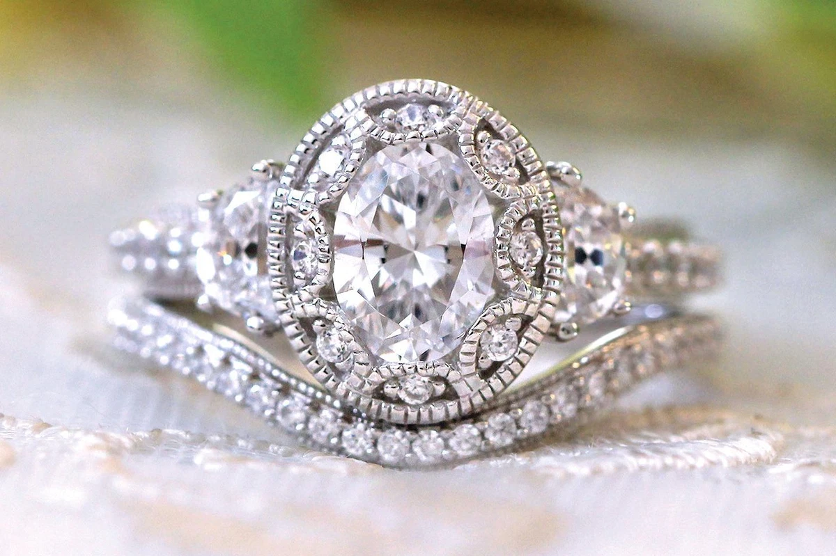 Oval engagement ring deals with curved wedding band