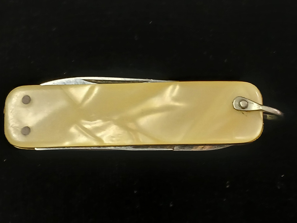 Italian-made vintage Latama multi-tool with a stunning mother-of-pearl handle — functional antique that looks like it belongs in a film noir scene.
