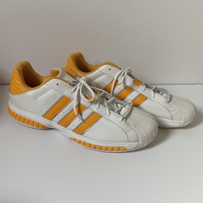 black and yellow shell toe adidas