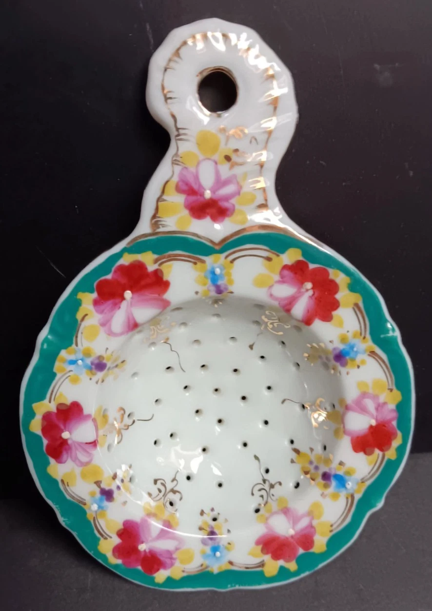 Antique porcelain tea strainer, 6 x 4.25, multi-colored floral trimmed with gold