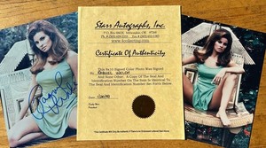 Two Raquel Welch photos - one autographed, one print. Certificate with autograph