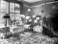 Collection of lamps in a front room including table and wall lamps 1925 Photo