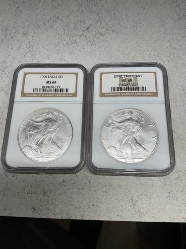 lot of two milk spotted .999 silver eagles, 1996 (rare) and 2002 both NGC MS69