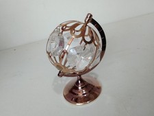 globe shaped ornament. glass pieces in a gold coloured frame. on a stand