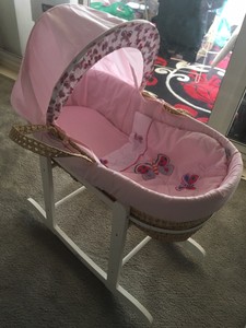 pink moses basket with rocking stand