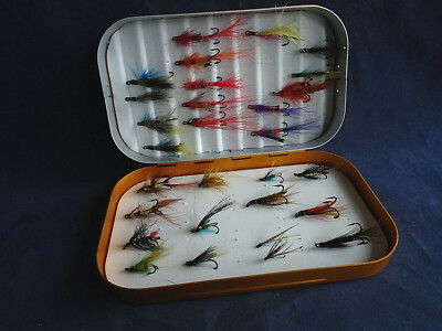 A VERY GOOD VINTAGE ORANGE/GOLD COLOURED FLY BOX + SALMON FLIES ETC.