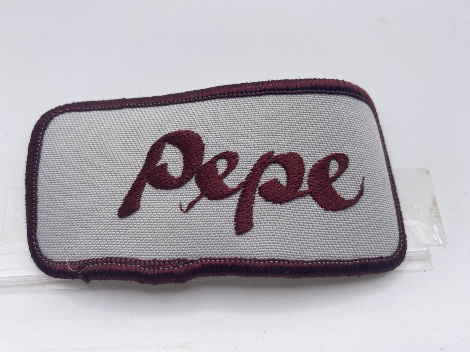 PEPE USED EMBROIDERED VINTAGE SEW ON NAME PATCH TAG MAROON ON GREY