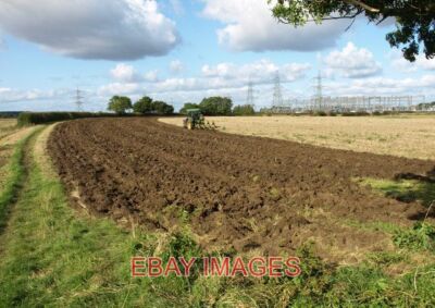 PHOTO  COTTINGHAM PLOUGHER AND POWER IN THE FOREGROUND A FARMER TURNS OVER HIS H