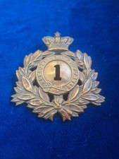 1ST REGIMENT OF FOOT VICTORIAN SHAKO PLATE BADGE IN BRASS ON LUGS