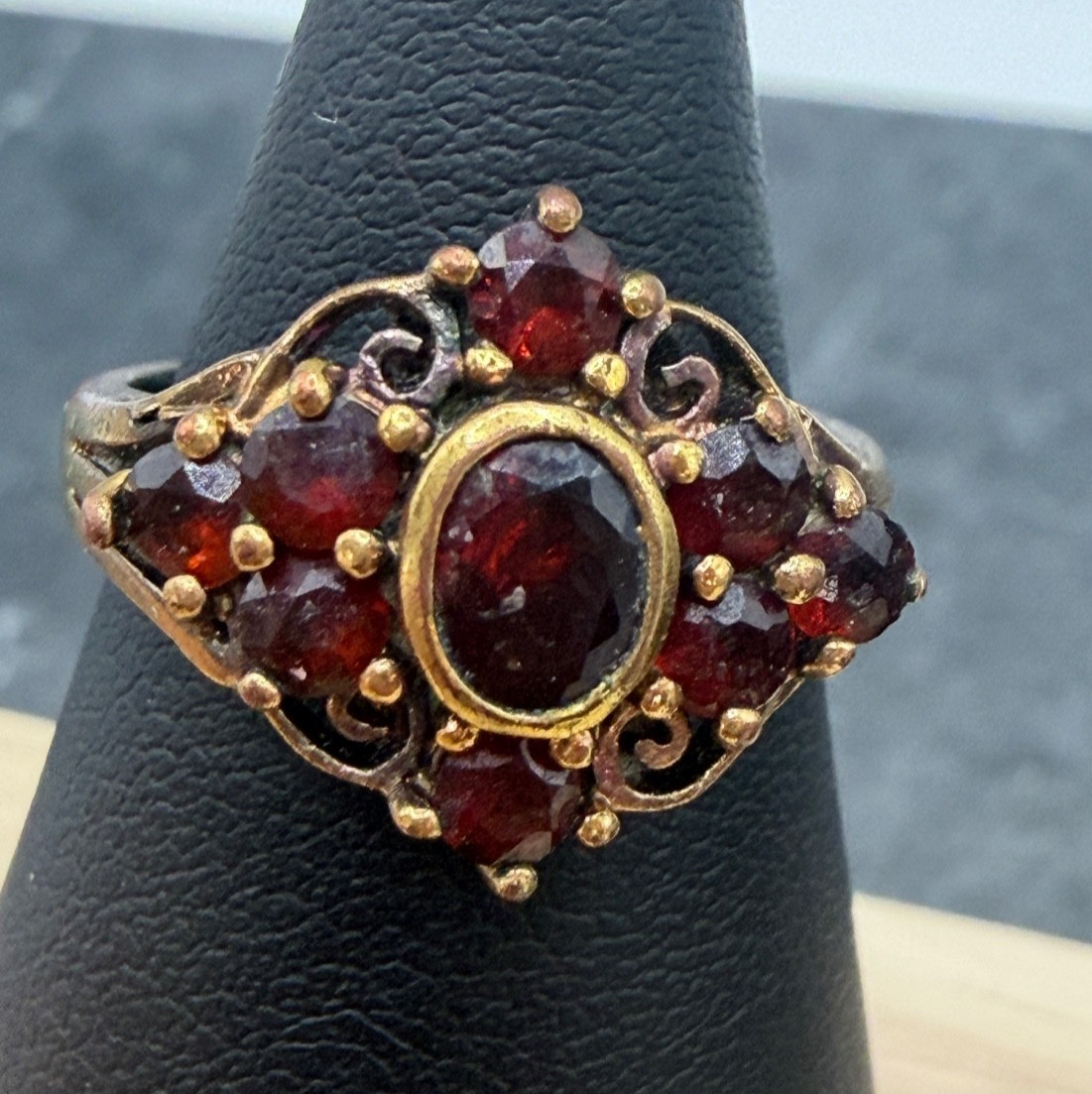 Gold vermeil sterling silver ring with a cluster of small red garnet stones.