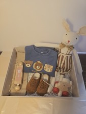 Baby Hampers With A Plush Toy And Rattle And A Dress.