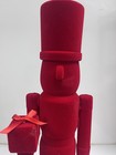Red Christmas toy soldier with gift in hand ￼ — photo 5