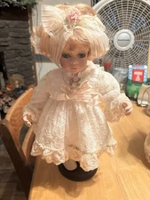 Vintage Porcelain Doll in Lace Dress with Bow and Floral Accents