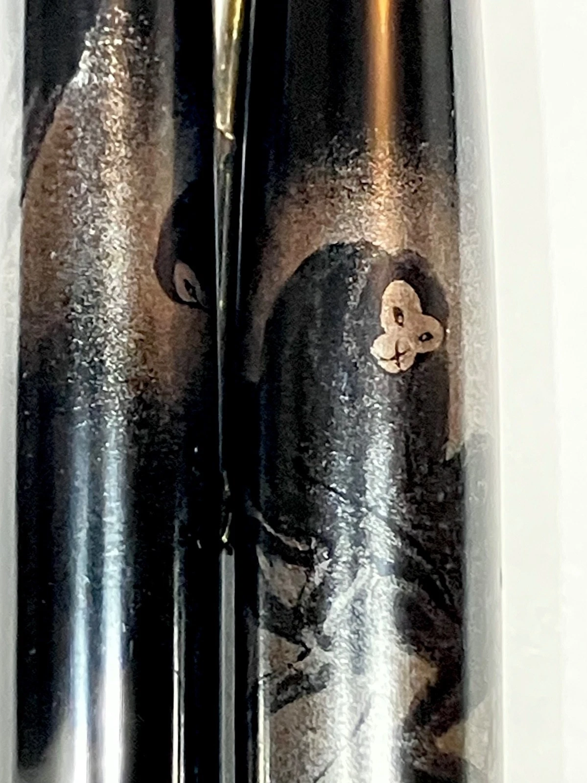 Vintage ink shut off fountain pen with urushi maki-e body, featuring small white monkey design on left side.