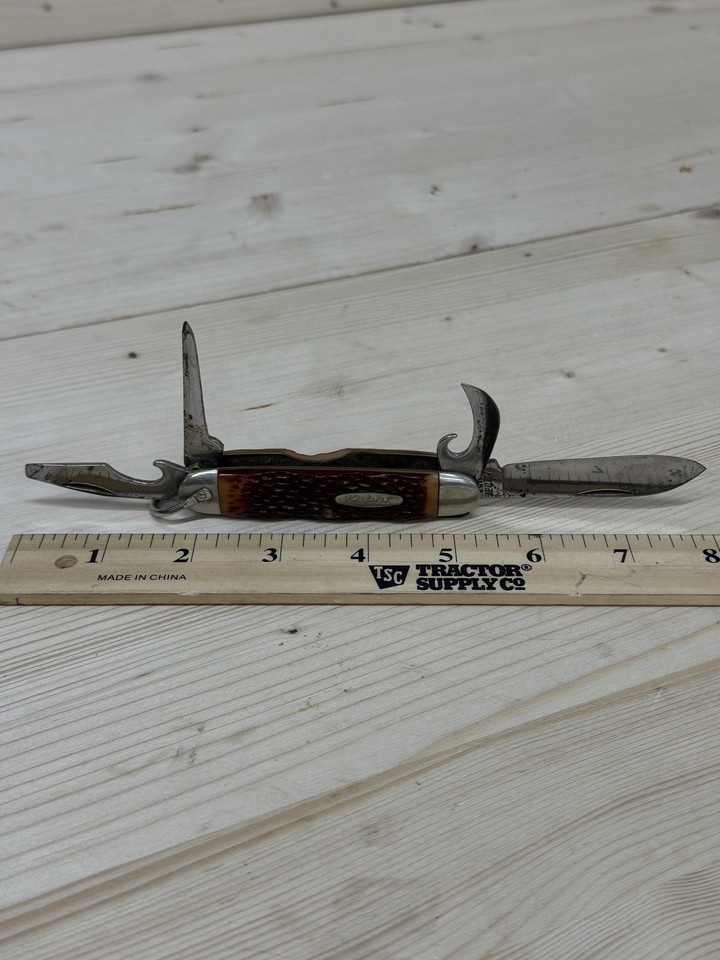 A USA-made Ka-Bar folder with classic jigged bone handle and multi-tool functionality — the kind of working knife your grandfather actually carried.