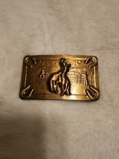 Vintage ornate brass belt buckle of a cowboy on a bucking bronco W/4 horseshoe s