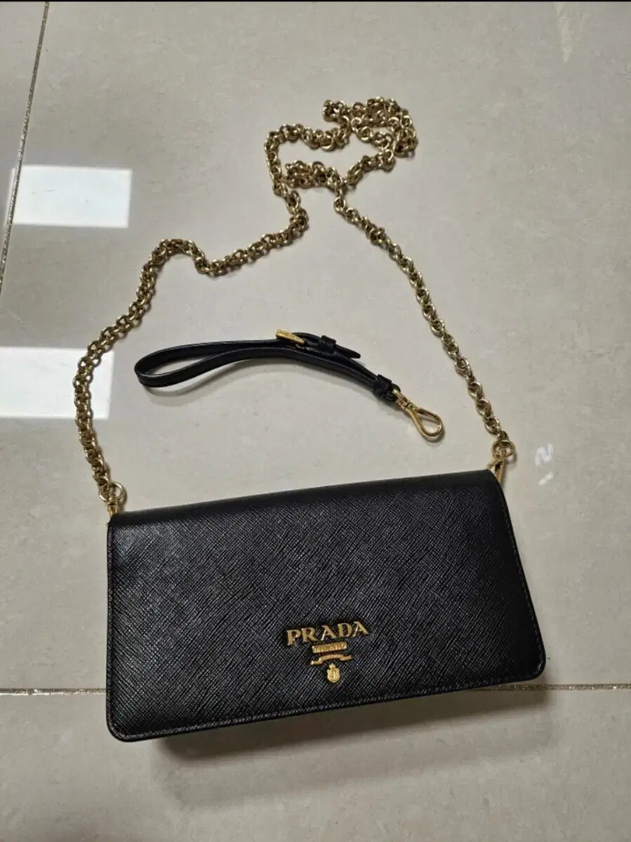 Prada mini crossbody bag in saffiano leather with gold-tone hardware