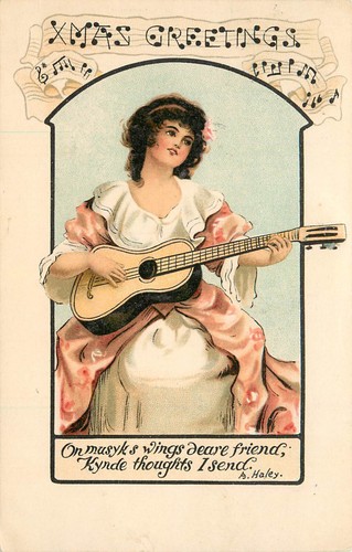 Weihnachts-Postkarte Weihnachtsgrüße buchstabiert in Musiknotation Frau spielt Gitarre