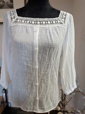 Lightweight white blouse featuring a distinctive square crochet-lace neckline...