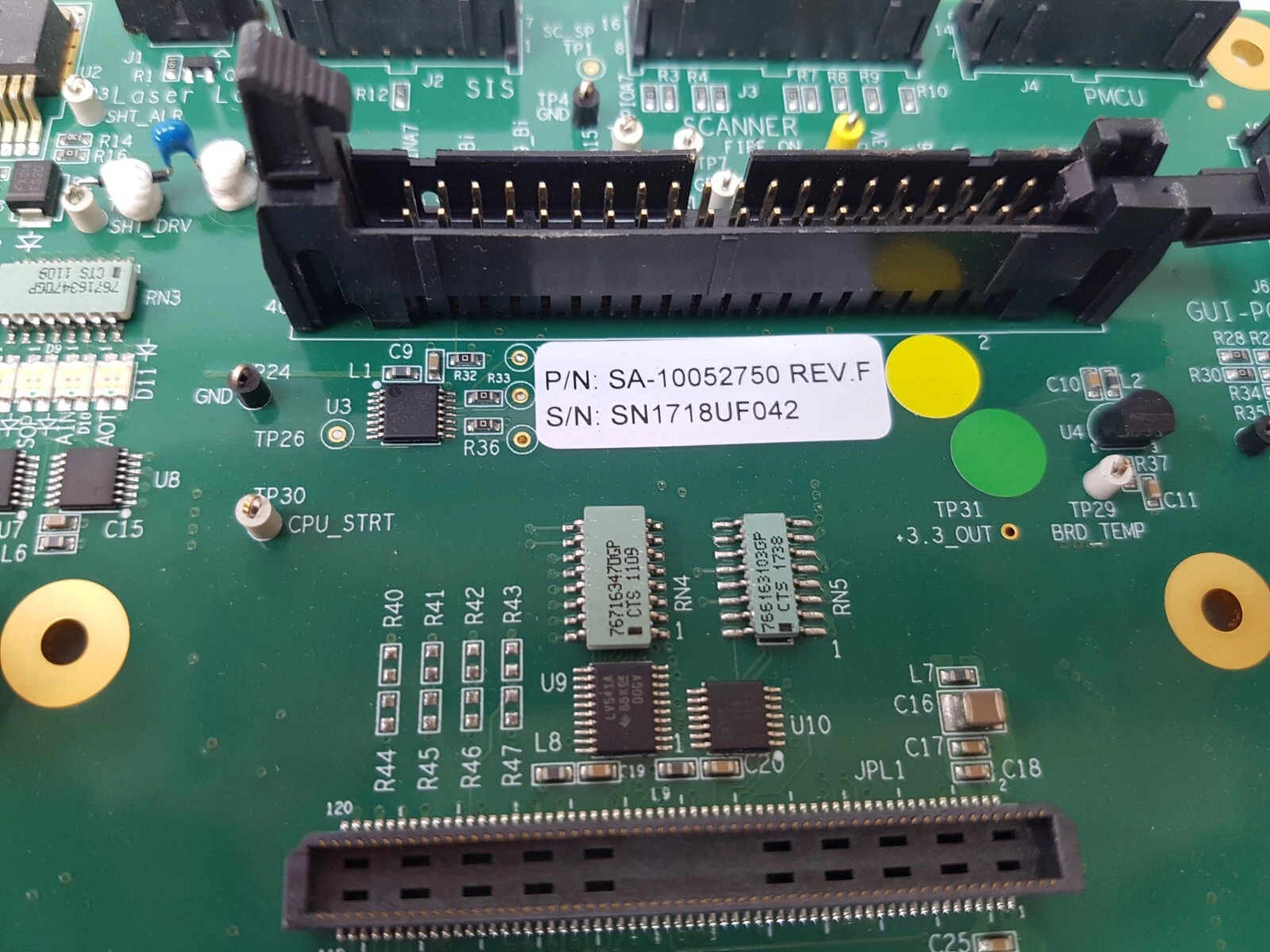 Close-up of the SA-10052750 REV.F label with the SIS, SCANNER and PMCU connectors