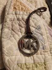 Michael Kors MK Silver Metal Purse Charm Hang tag With Brown Leather Strap