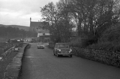 L Taylor and M Phillips' Morris Mini Minor is trailed by an Aust- 1960 Photo