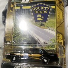 Greenlight 1:64 County Roads 2008 Ford Crown Victoria Police Black/Gold Diecast