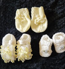 Bundle Of Hand Knitted Baby Booties And Yellow Mittens