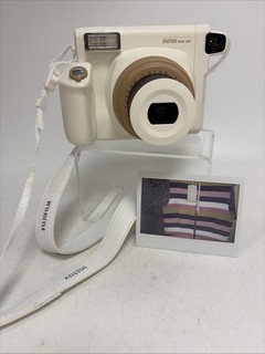 Fujifilm Instax Wide 300 camera in the "Toffee" (white and brown) colorway.