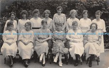 R341930 Many women sit on chairs and stand in the garden Postcard