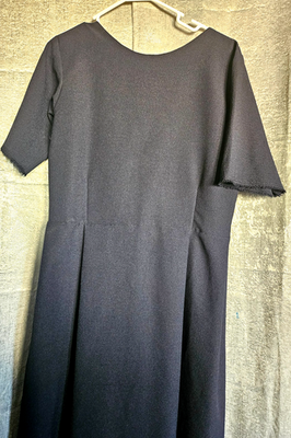 knee length dresses for ladies Amish woman wearing a black dress with a white apron and cap (Lauren 0784)