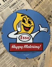VINTAGE 1962 ESSO GASOLINE HAPPY MOTORING 12 INCH PORCELAIN ENAMEL SIGN
