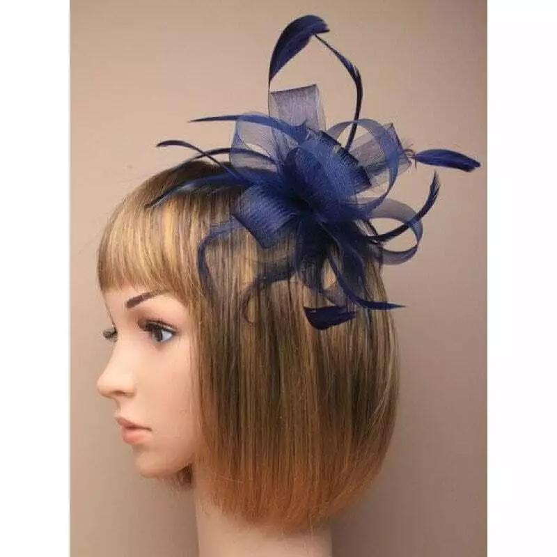 Navy blue fascinator with sinamay loops and feather tendrils set on hair comb
