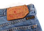 Brown medium wash VTG Lucky Brand jeans with paint splatter on leg, American Classic, and USA Made label on back pocket.