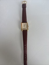 Merit gold face watch with brown leather band