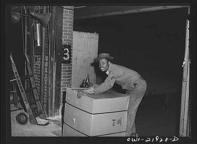 Photo:1920s Man Loading Boxes in Warehouse, Workers District 3